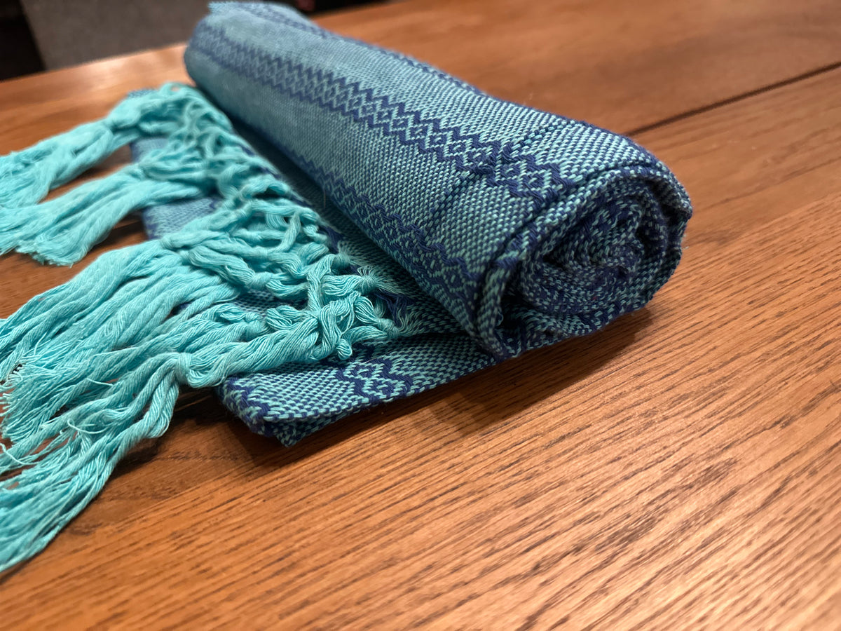 Rolled Agua de Mar handwoven Mexican cotton rebozo in turquoise aqua with navy-blue diamond stripes and turquoise knotted fringe | Lola My Love