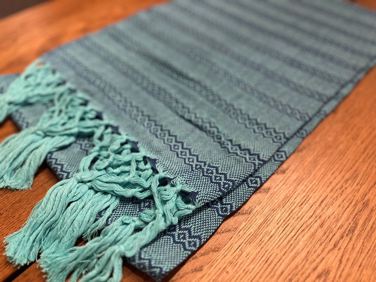Close-up of the Agua de Mar rebozo's navy-blue diamond stripes and turquoise hand-knotted fringe | Lola My Love