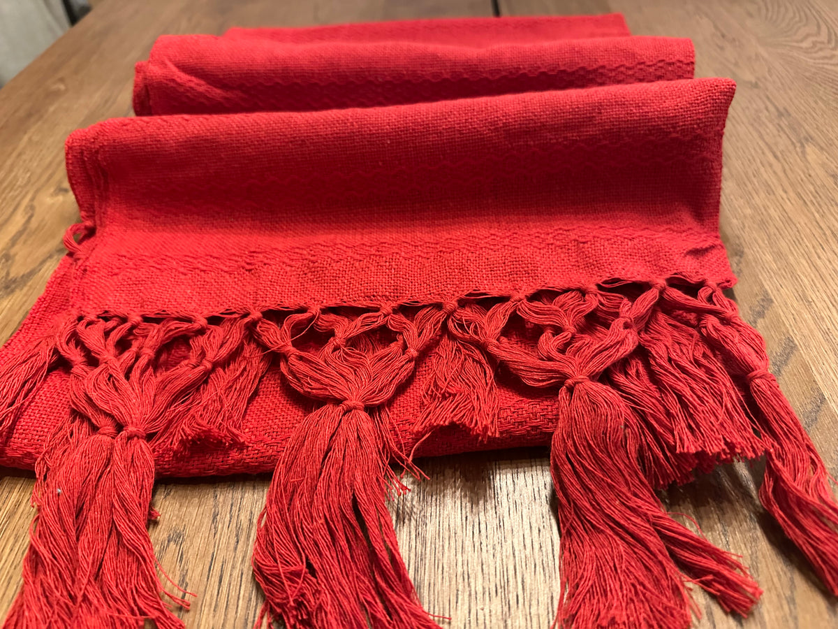 Chile Rojo solid red cotton rebozo shawl folded with hand-knotted fringe and subtle chevron weave | Lola My Love