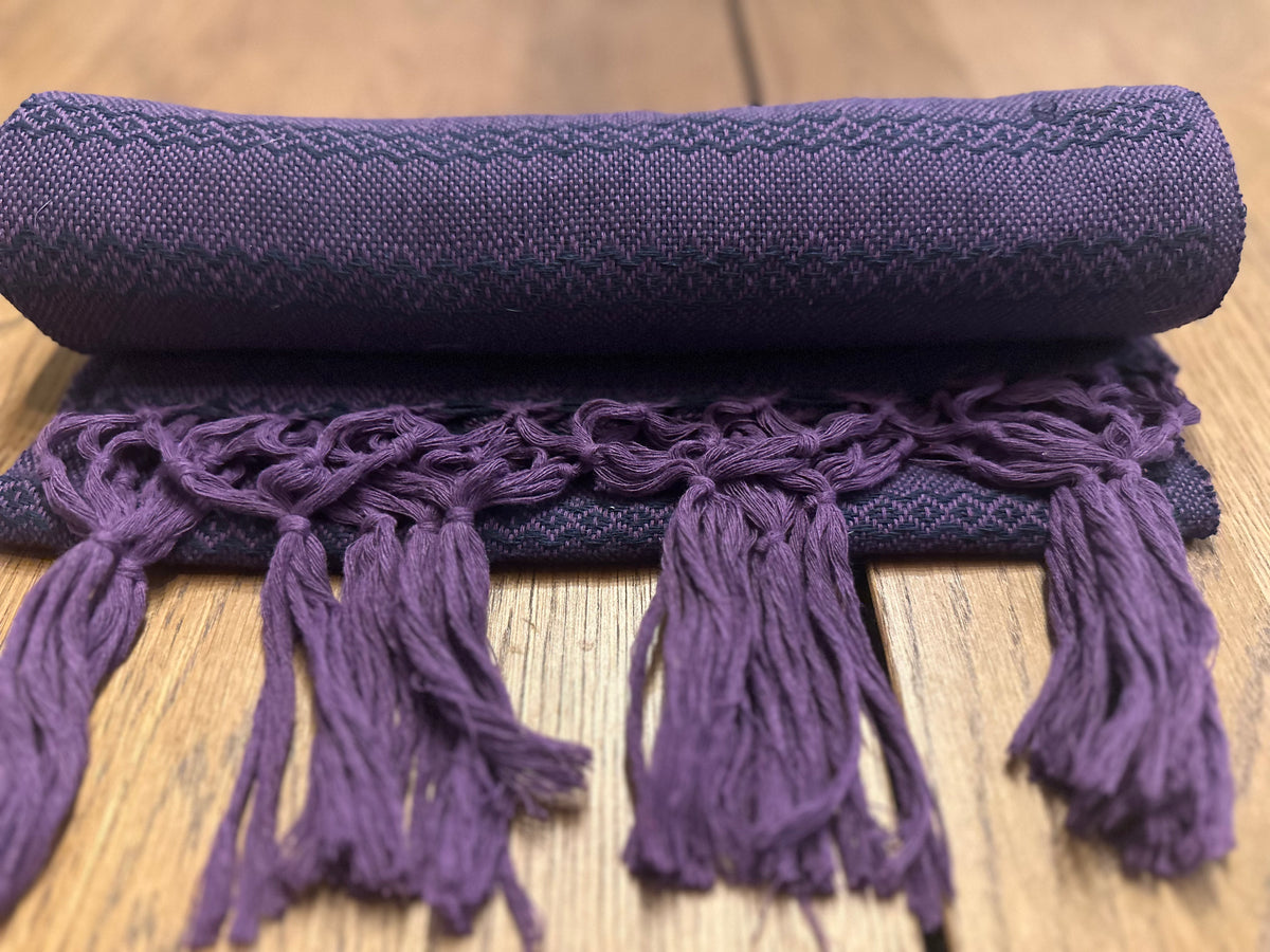 Rolled Jacaranda Magic cotton rebozo shawl with purple hand-knotted fringe in front | Lola My Love