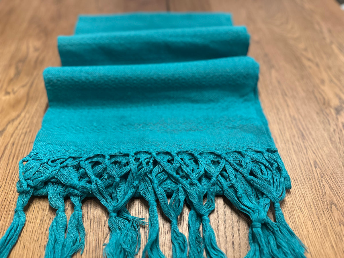 Jade Maya solid teal cotton rebozo shawl folded in layers with matching knotted fringe | Lola My Love
