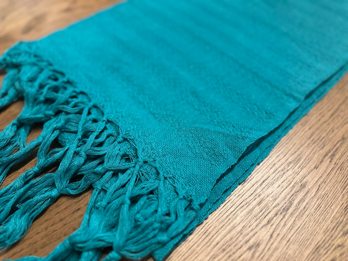 Close-up of the Jade Maya rebozo's subtle woven texture and teal hand-knotted fringe | Lola My Love