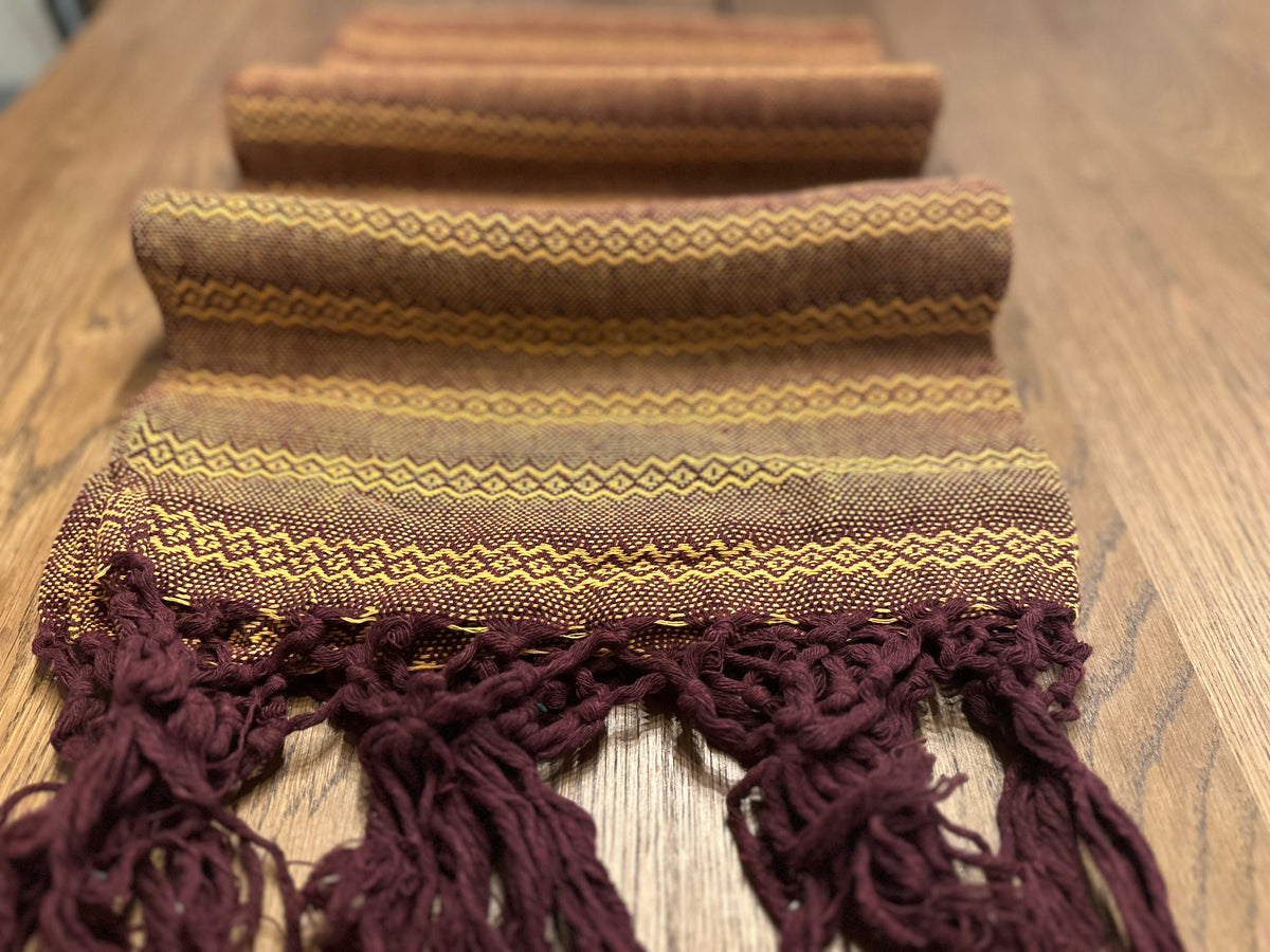 Mole Dorado burgundy cotton rebozo shawl folded in layers with golden diamond stripes and burgundy fringe | Lola My Love