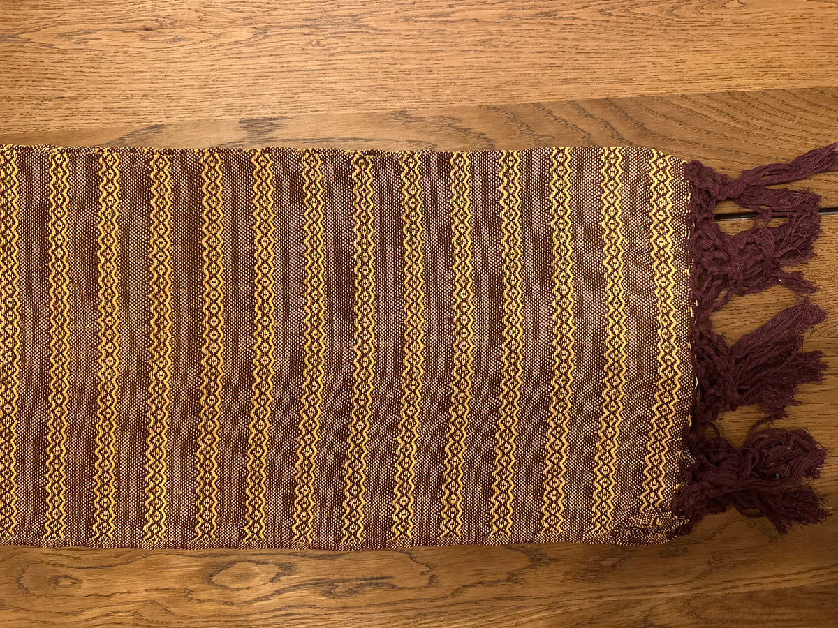 Mole Dorado handwoven Mexican cotton rebozo flat lay — burgundy with golden stripes and burgundy fringe | Lola My Love