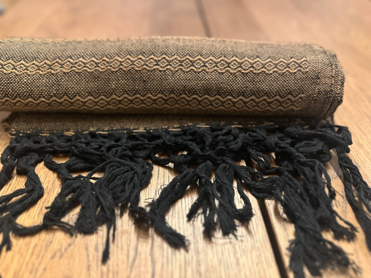 Rolled Noche de Mezcal handwoven rebozo with black hand-knotted fringe in front | Lola My Love