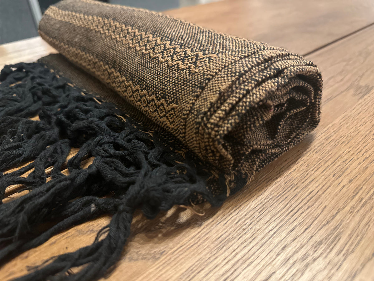Rolled Noche de Mezcal Mexican rebozo showing the black and golden-tan diamond-stripe cotton weave | Lola My Love