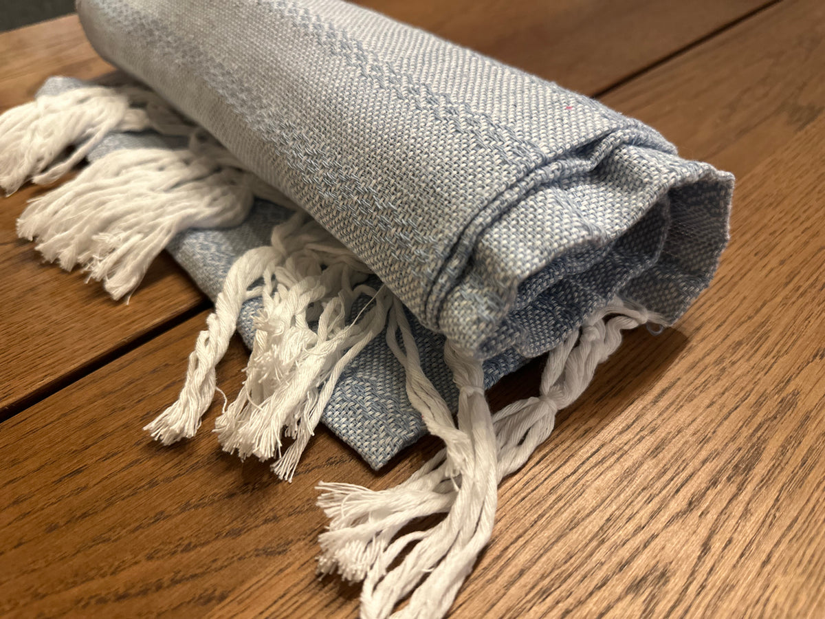 Rolled Talavera Azul handwoven Mexican cotton rebozo in dusty sky blue with white diamond stripes and white knotted fringe | Lola My Love