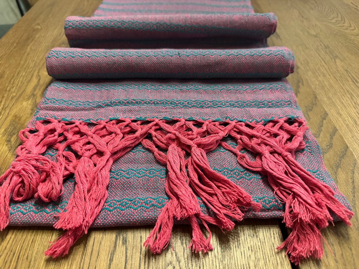 Tuna Rosa hot pink cotton rebozo shawl folded in layers with teal stripes and pink knotted fringe | Lola My Love